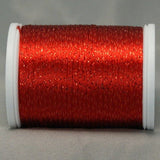 Red metallic rayon thread on white plastic spool, showing shimmery reflective finish