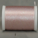 Soft pink metallic rayon thread on white plastic spool, showing shimmer and texture on neutral background