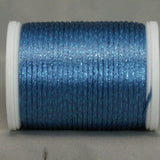 Smokey ice blue rayon metallic thread on white plastic spool with visible shimmer and gradient coloring
