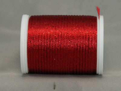 Wine red metallic thread on white plastic spool with loose thread end visible