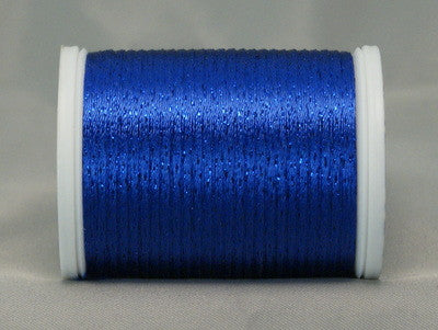 Royal blue metallic thread on white plastic spool, wound with glossy rayon and metallic blend thread