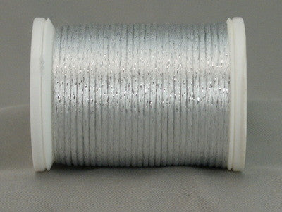 White and silver metallic rayon thread on white plastic spool, showing lustrous finish and tight winding