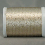 Ecru and gold metallic rayon thread on white plastic spool with shimmery, textured appearance