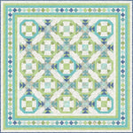 Geometric batik quilt kit in aqua, green, and navy featuring octagonal blocks with connecting sashes and decorative diamond border