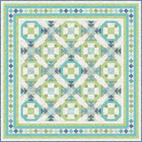 Geometric batik quilt kit in aqua, green, and navy featuring octagonal blocks with connecting sashes and decorative diamond border