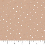 Light brown background with scattered white dots.