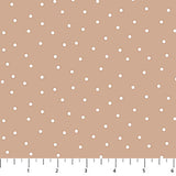 Light brown background with scattered white dots.