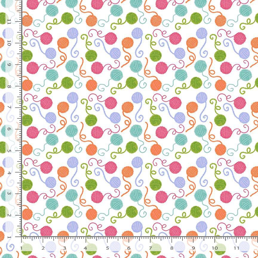 White background with multi colored yarn balls.