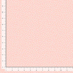 Light peachy pink background with soft dots.
