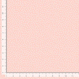 Light peachy pink background with soft dots.