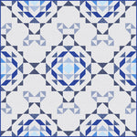 Blue and white geometric quilt with intricate star and diamond patterns in various shades of blue on cream background