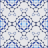 Blue and white geometric quilt with intricate star and diamond patterns in various shades of blue on cream background