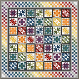 Colorful rainbow sampler quilt with 49 blocks featuring various traditional patterns in gradient colors from purple to red with checkered border