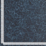 Dark blue tonal batik with wandering lines crisscrossing.