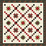 Red and green batik star quilt with diamond blocks on cream background, featuring floral border in traditional Christmas colors
