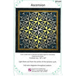 A geometric quilt pattern featuring a radiating star design in yellow, navy, and gray fabrics with triangular piecing and dark borders.