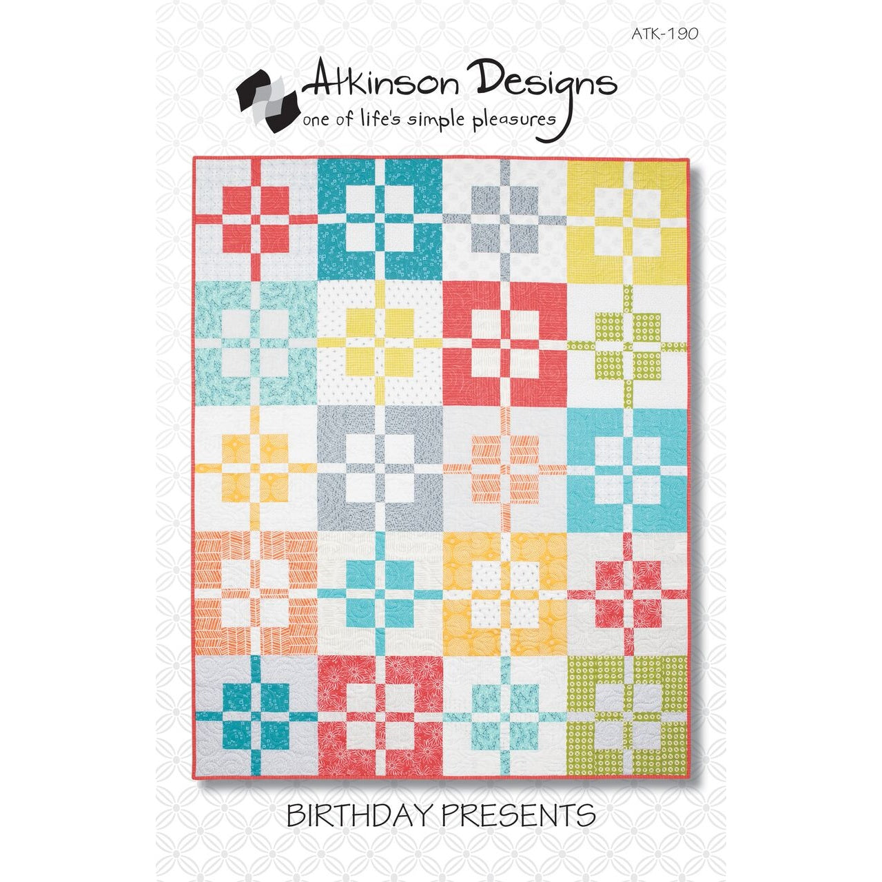 A colorful quilt pattern featuring cross-shaped blocks in various bright fabrics including coral, teal, yellow, and green arranged in a geometric grid layout.