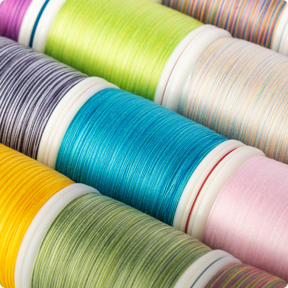 spools of Majestic extra-long staple cotton thread in a colorful pattern