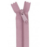Dusty rose pink zipper with matching pull tab, displayed open against white background.