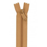 Golden brown closed-end zipper with matching pull tab and fabric tape