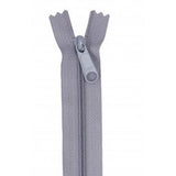 Gray zipper with matching pull tab, showing the zipper partially open at the top