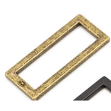 Rectangular metal ring in antique brass finish with weathered, distressed texture and visible brand marking.
