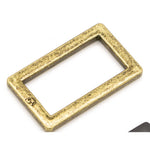 Antique brass rectangular metal ring with weathered golden finish and rounded corners.