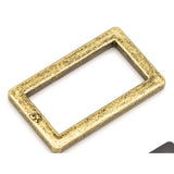Antique brass rectangular metal ring with weathered golden finish and rounded corners.