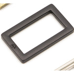 Black metal rectangular ring with flat edges and rounded corners on white background.