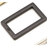 Black metal rectangular ring with flat edges and rounded corners on white background.