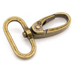 Antique brass swivel hook with weathered golden finish and oval ring attachment.