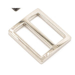 Silver-toned metal belt buckle slider with rectangular frame and adjustable bar, featuring a small logo marking.