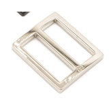 Silver-toned metal belt buckle slider with rectangular frame and adjustable bar, featuring a small logo marking.