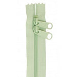 Light mint green 30-inch zipper with two pull tabs and decorative scalloped tape edges.