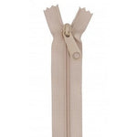 Beige or tan colored 24-inch zipper with matching pull tab, shown partially open against white background.
