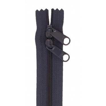 Navy blue 30-inch zipper with dual black pull tabs and teeth visible at the top opening.