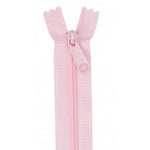 Pale pink zipper with plastic teeth and matching pull tab, displayed vertically against white background.
