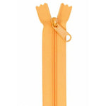 Orange zipper with pull tab, partially unzipped at the top, measuring 24 inches in length.