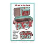 Sewing pattern for a floral picnic basket bag with turquoise and red fabric, featuring multiple compartments and storage pockets.