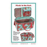 Sewing pattern for a floral picnic basket bag with turquoise and red fabric, featuring multiple compartments and storage pockets.