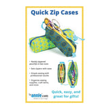 Colorful zippered pouches in green and blue patterns with circular and geometric designs, shown with sewing supplies inside and scissors on top.