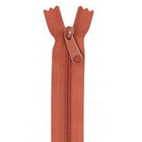 Redwood colored 24-inch zipper with matching pull tab, shown fully closed against white background.