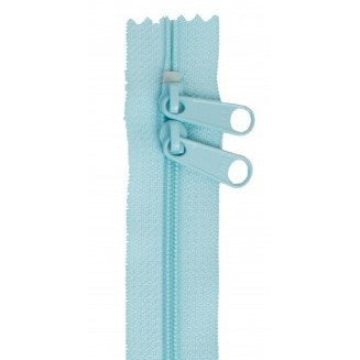 Light blue zipper with two pull tabs on a white background