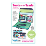 A colorful craft organizer portfolio with multiple pockets and compartments, featuring teal, green, and blue fabric sections for storing creative supplies.