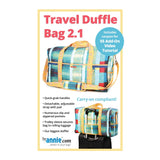 A colorful quilted duffle bag in turquoise, blue, and coral patches with yellow straps, shown both standalone and attached to rolling luggage.