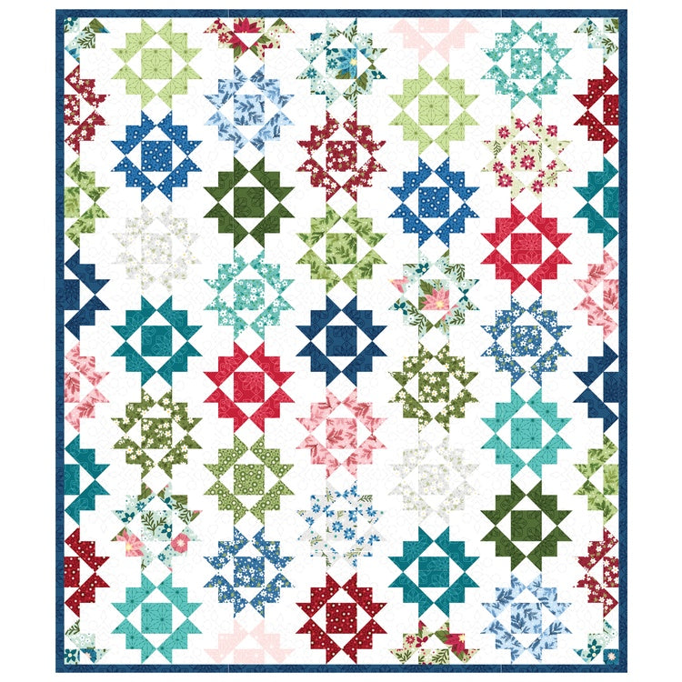 Colorful quilt featuring star-pattern blocks in blues, greens, reds, and teals with floral fabrics on white background.