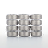 Twelve gray thread spools arranged in four rows of three, showing silver-gray thread wound on clear plastic bobbins