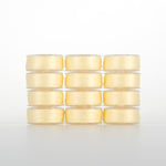 Twelve light yellow Dream Seam thread spools in 4x3 grid, pale cream to butter yellow shades in clear plastic cases