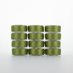 Olive green thread on clear plastic bobbins, stacked in four rows of three bobbins each