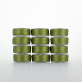 Olive green thread on clear plastic bobbins, stacked in four rows of three bobbins each